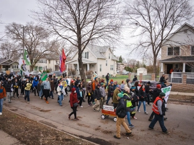 Supporters of EPNI and the East Phillips Indoor Urban Farm project march down Longfellow Avenue, across the street from the former Roof Depot, demanding a sustainable, prosperous, healthy, and self-determined future for the East Phillips neighborhood. Photo by Devon Young Cupery
